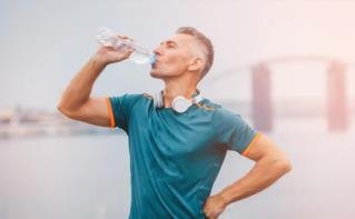 Person drinking from a plastic bottle